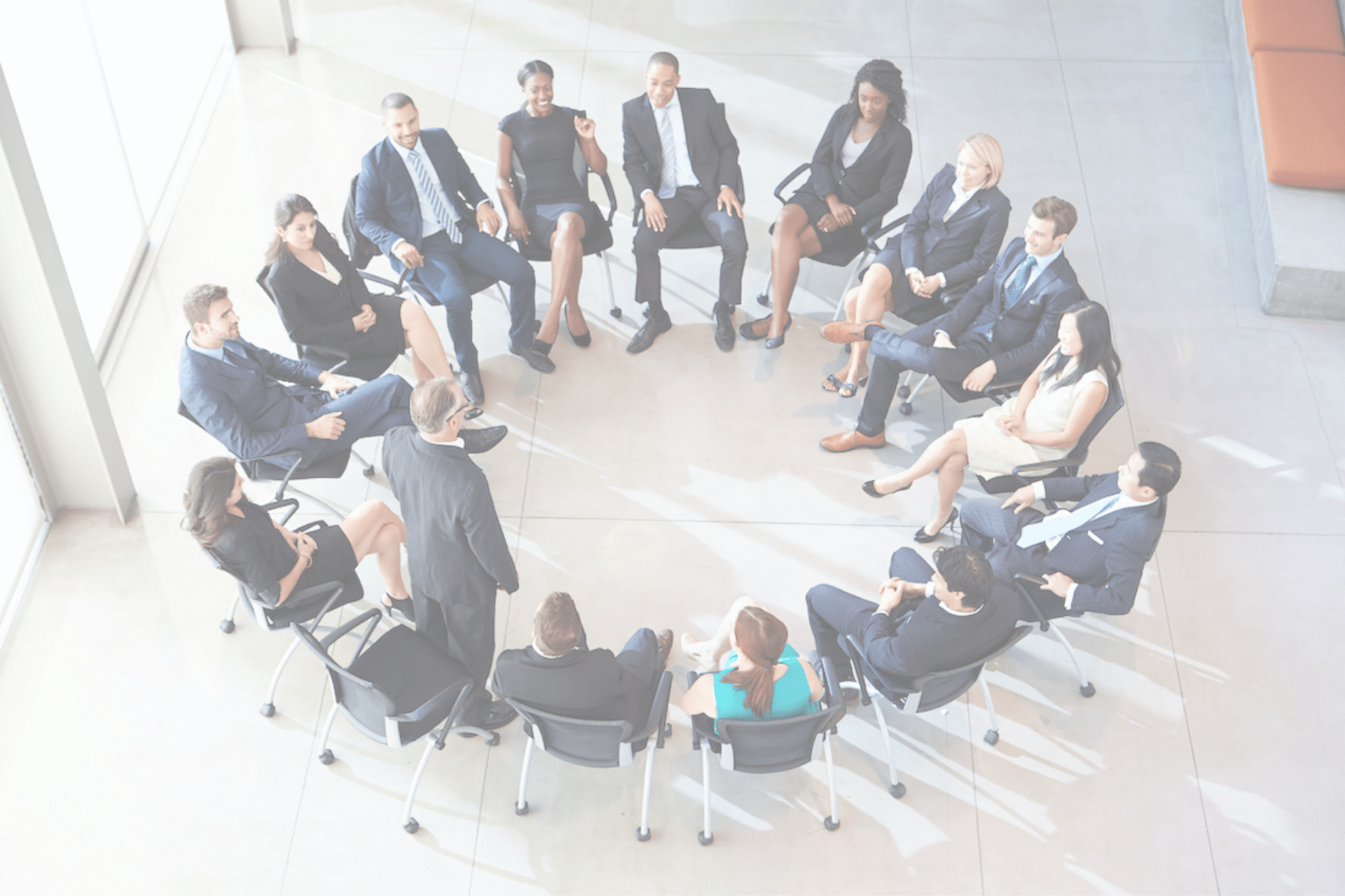 Businessperson Addressing Multi-Cultural Office Staff Meeting