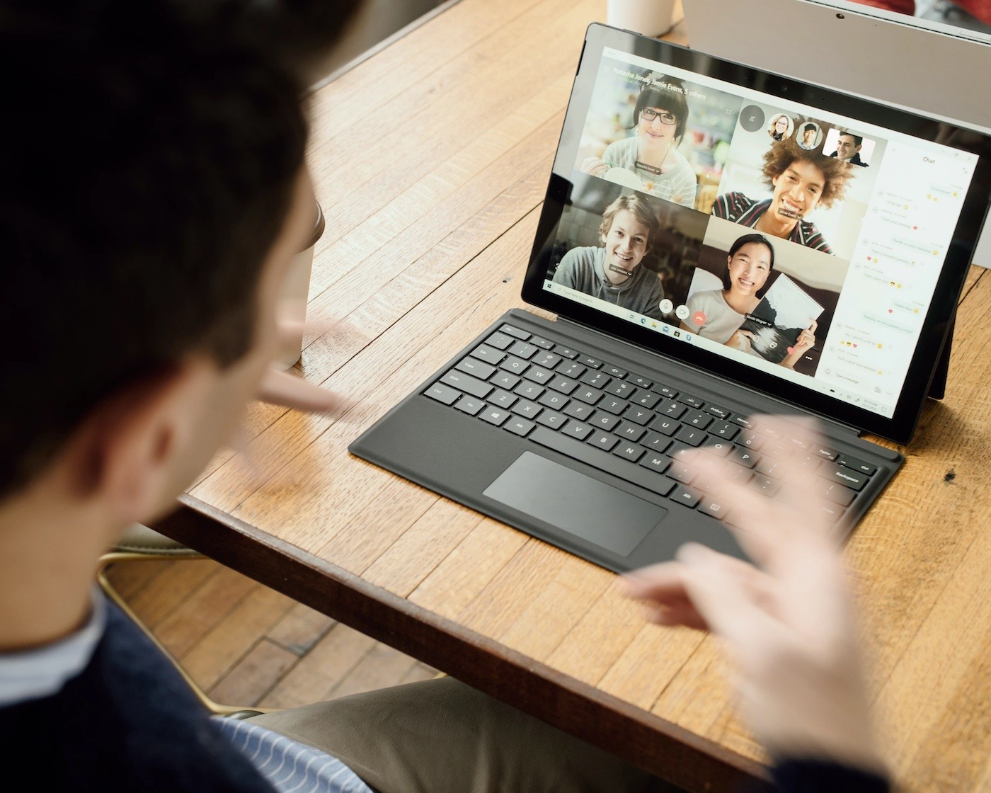 man working from home joins a video call with his colleagues