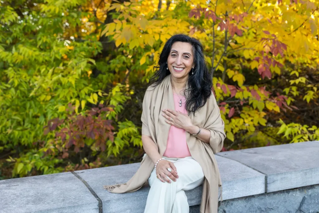 Image of Sonia sitting outside in the fall.