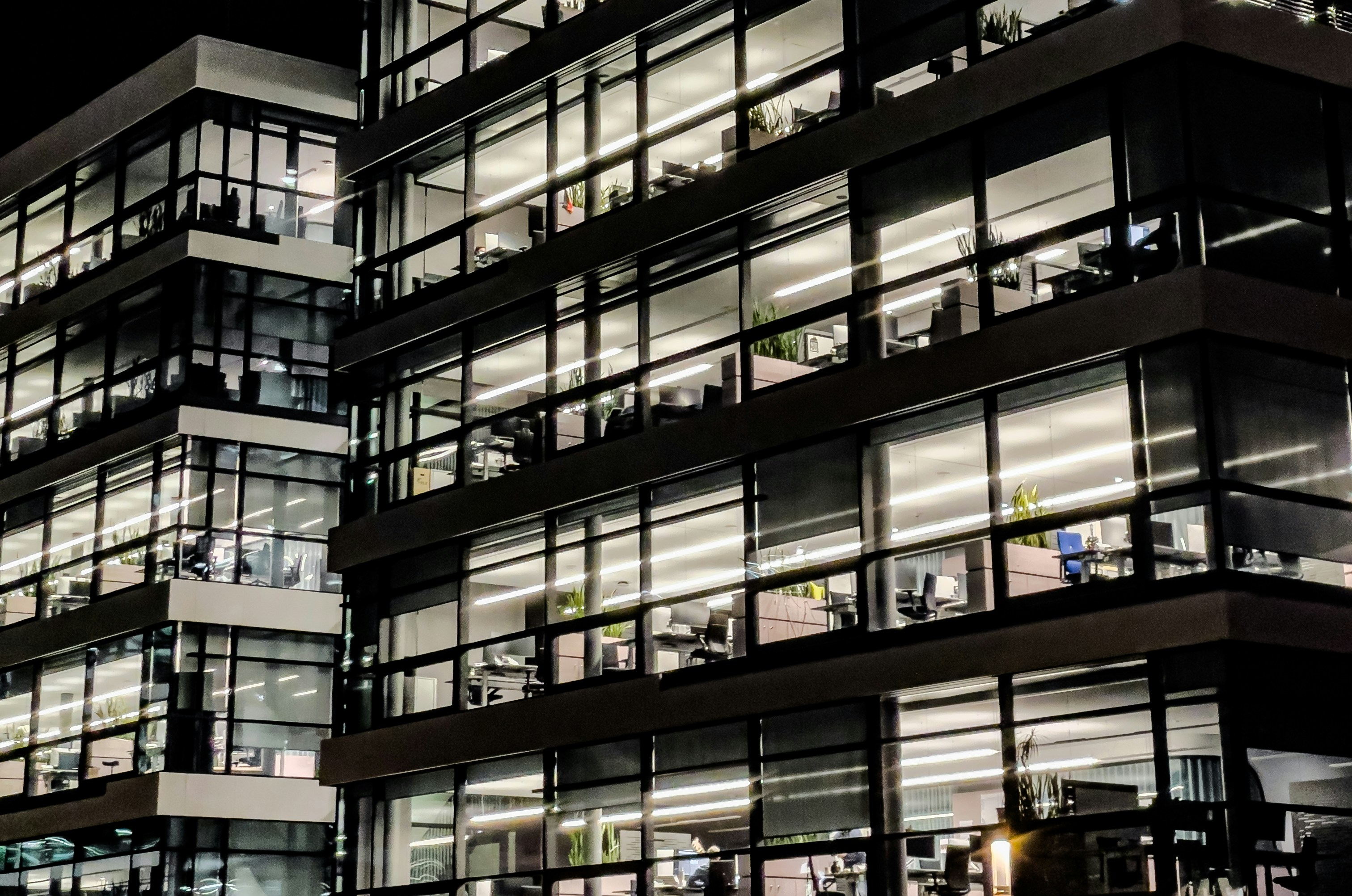 exterior view of busy office building at night