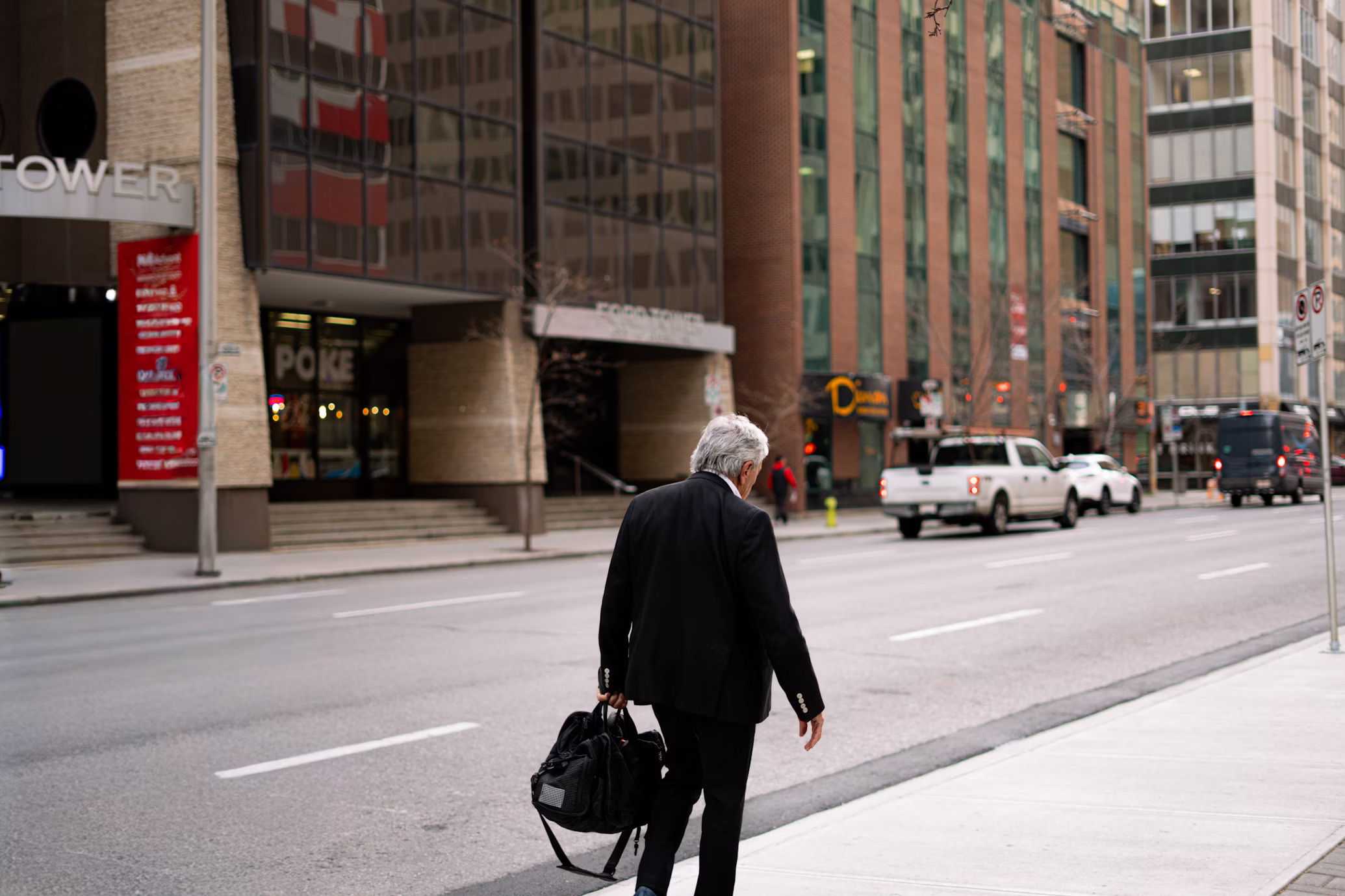 man in suit walks to work in the busy city
